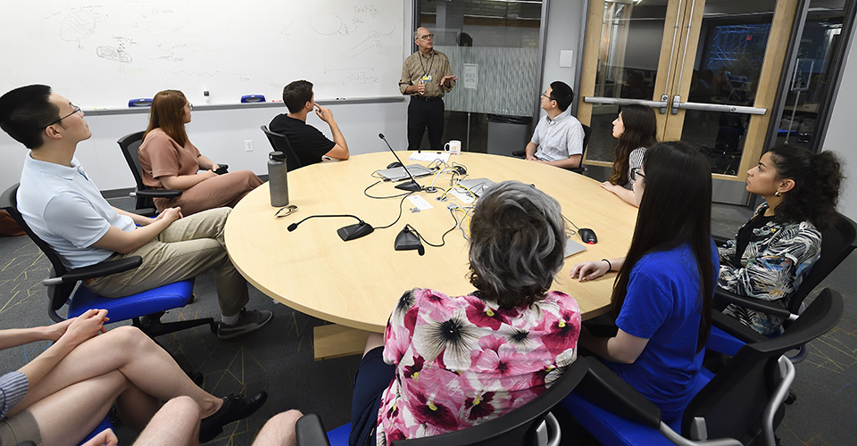 Faculty speaking to a class.