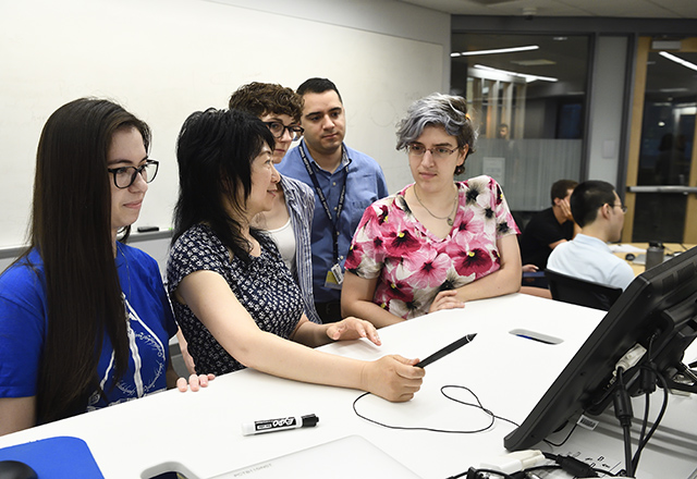 A professor with graduate students.