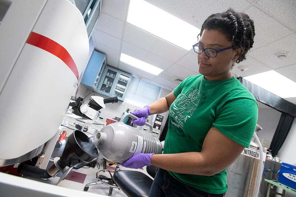 Researcher using an EM-ICE high-pressure freezer.