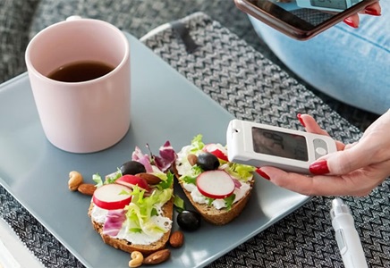 Adult diabetic woman having breakfast at home.