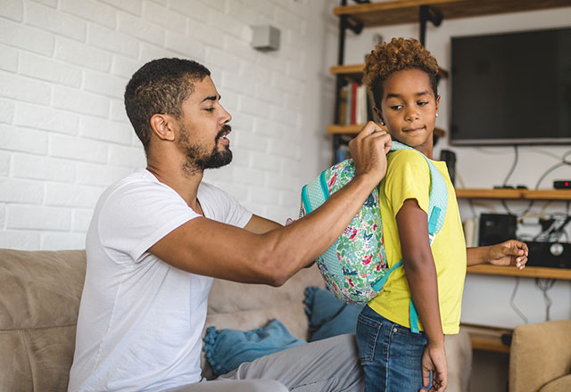 Father helping son prepare for school