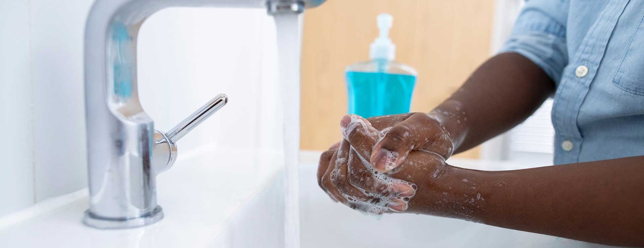 boy washing hands with soap