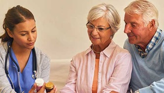 man and woman reviewing medicine with nurse