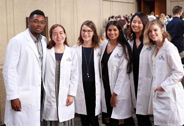 Vondel Mahon, Alisa Brandt, Brittany Bennett, Lohitha Kethu, Insil Choi and Cecelia Johnson, wearing their white coats. Photo credit: Gene Chung.