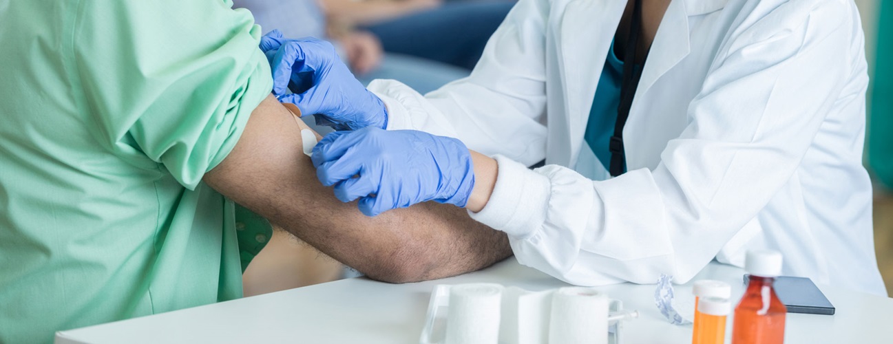 A man gets a bandage on his arm after getting a vaccine