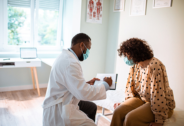 doctor and patient talking in exam room