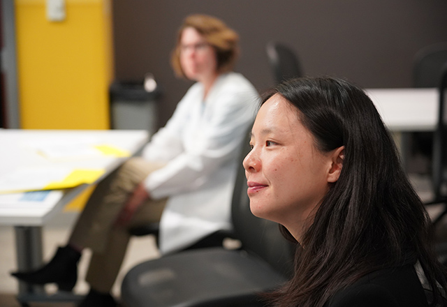 Faculty members listen with rapt attention.