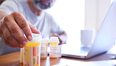 hand grabbing medicine bottle