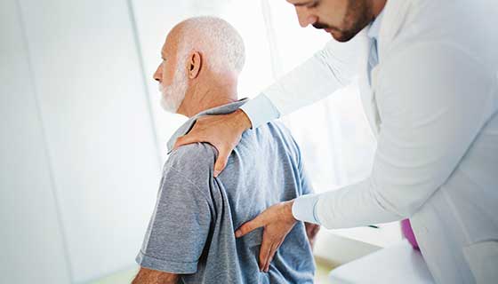 Doctor examining patient's lower back