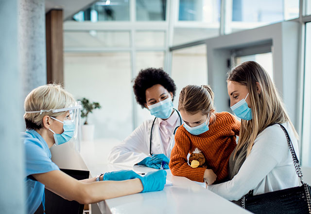 parent checking a child into a hospital