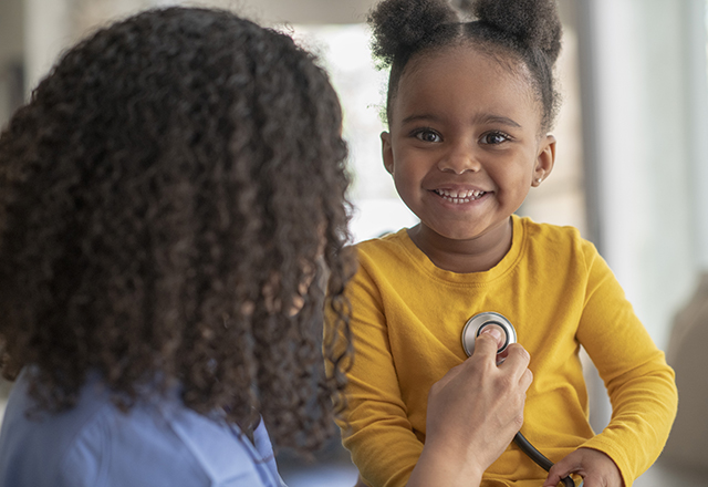 doctor listening to girl's chest - pediatric and congenital heart center