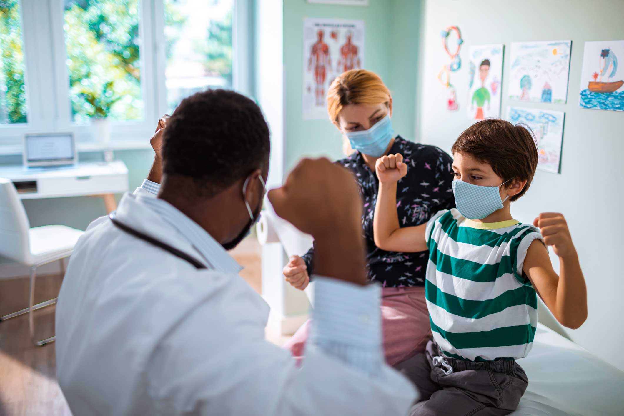 kid showing strength to doctor