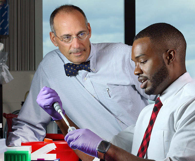 Robert Brodsky mentors Jason Vaught in the lab.