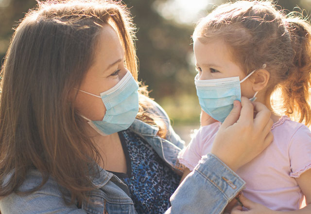 Masked mother and daughter