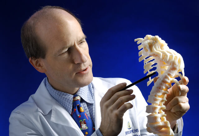 Dr. Sponsellor pointing to a model spine