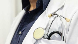 A close-up of a stethoscope in a doctor's pocket.