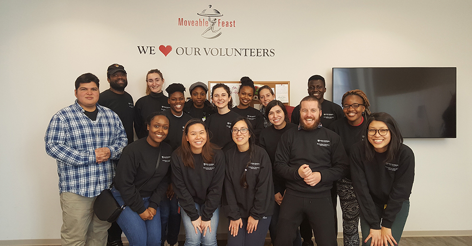 Students pose together during a volunteering event.