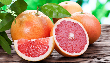 Cut grapefruit displayed on a wood table